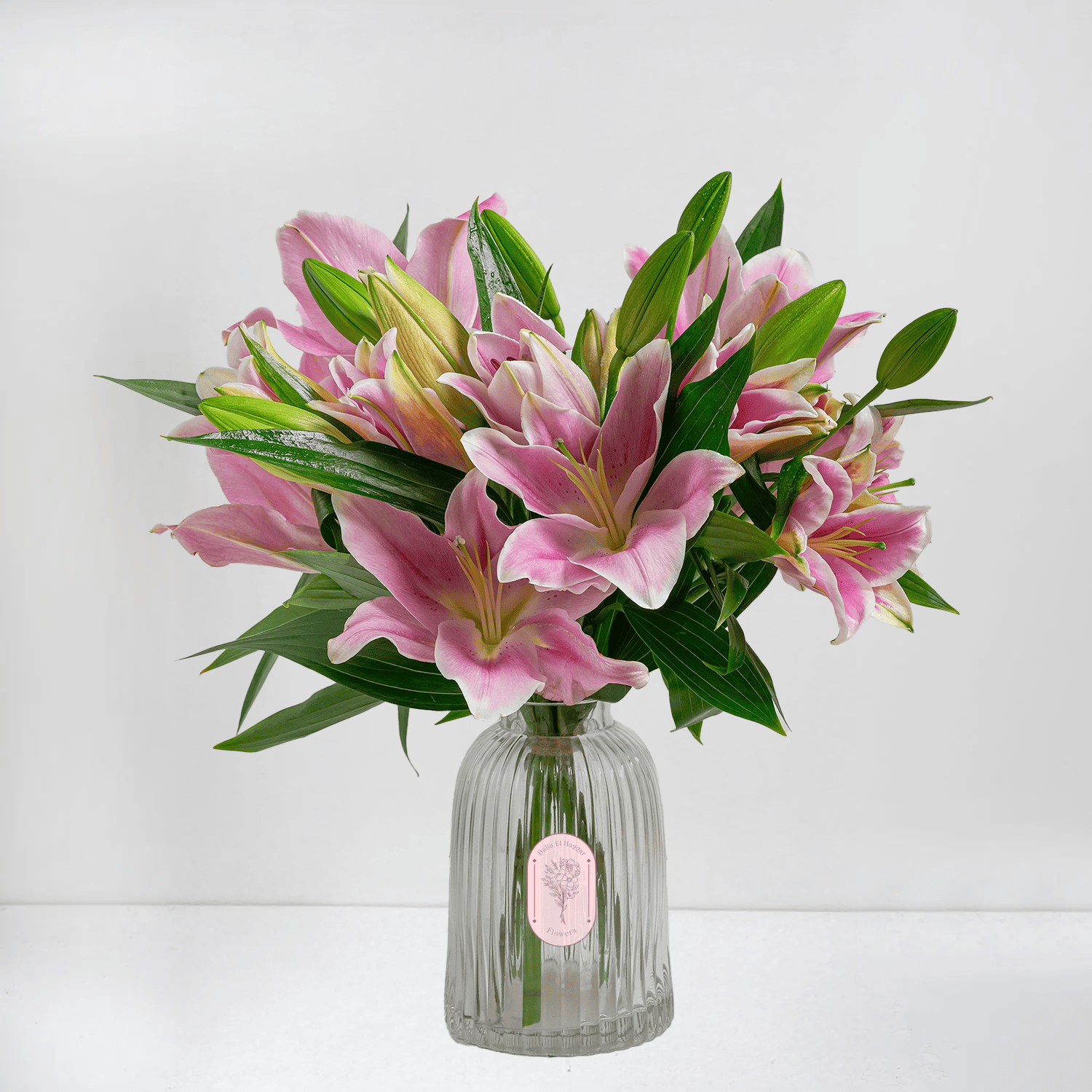 Pink Lilies & Lush Greens in Refreshing Glass Vase